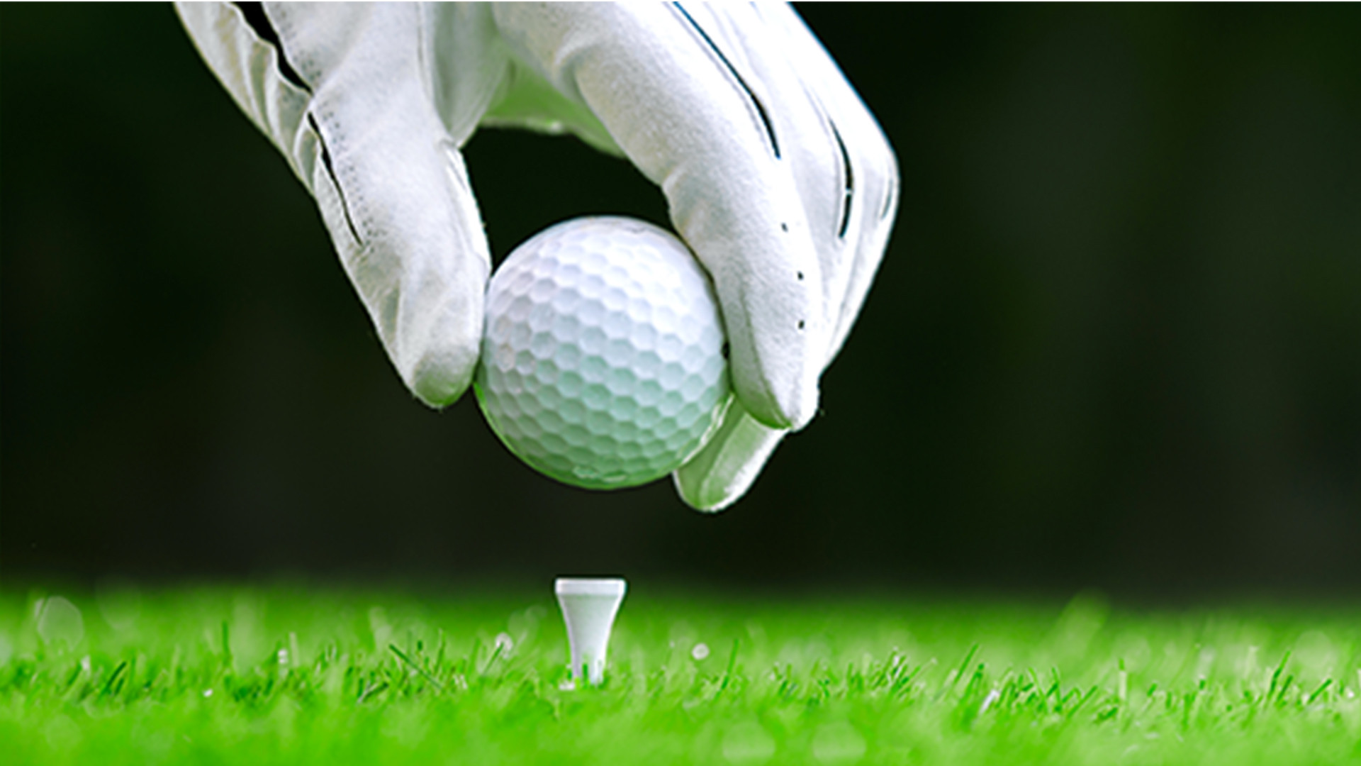 placing golf ball on a tee